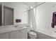 Bright bathroom features a large mirror, vanity with white cabinets, and a combined shower and tub at 7716 Uliva Way, Sarasota, FL 34238