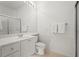 Clean bathroom features white cabinets, a sink, and a shower with glass doors at 7716 Uliva Way, Sarasota, FL 34238
