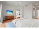 Bright bedroom with a ceiling fan, outdoor views, and wood floors at 7716 Uliva Way, Sarasota, FL 34238
