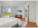Bright bedroom with a ceiling fan, outdoor views, and wood floors at 7716 Uliva Way, Sarasota, FL 34238