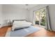 Bright bedroom with a ceiling fan, outdoor views, and a plush rug at 7716 Uliva Way, Sarasota, FL 34238