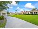 Beautiful clubhouse surrounded by lush landscaping and well-manicured lawns at 7716 Uliva Way, Sarasota, FL 34238