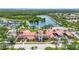 Stunning aerial view of a community center with a pool, tennis courts, and beautiful landscaping at 7716 Uliva Way, Sarasota, FL 34238