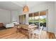 Dining area with wood floors, an outdoor view, and an open view into the living room at 7716 Uliva Way, Sarasota, FL 34238