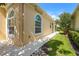 Exterior view highlighting well-maintained landscaping and an architectural window for ample natural light at 7716 Uliva Way, Sarasota, FL 34238