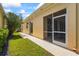 Exterior view featuring a covered lanai, smooth stucco, and lush green landscaping, highlighting a relaxing outdoor living space at 7716 Uliva Way, Sarasota, FL 34238