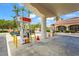 A Shell gas station with multiple pumps surrounded by lush landscaping and golf cart parking at 7716 Uliva Way, Sarasota, FL 34238