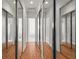 Hallway lined with mirrored closet doors and views to other rooms at 7716 Uliva Way, Sarasota, FL 34238