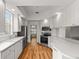 Spacious kitchen with white cabinets, stainless steel appliances, and wood-look floors at 7716 Uliva Way, Sarasota, FL 34238