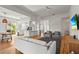 Bright living room featuring a kitchen with a breakfast bar and comfortable modern seating at 7716 Uliva Way, Sarasota, FL 34238
