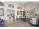 Elegant lounge area with hardwood floors, comfortable chairs, a buffet, and stylish décor at 7716 Uliva Way, Sarasota, FL 34238