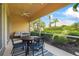 Comfortable patio area with seating and dining options, showcasing a lovely garden view and serene outdoor living at 7716 Uliva Way, Sarasota, FL 34238