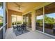 Outdoor patio features a dining area, comfortable seating, and expansive sliding glass doors to the home at 7716 Uliva Way, Sarasota, FL 34238