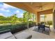 Relaxing screened patio with outdoor seating, lush landscaping, and a tranquil view of the backyard at 7716 Uliva Way, Sarasota, FL 34238