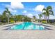 Sparkling community pool with clear blue water and inviting lounge area at 7716 Uliva Way, Sarasota, FL 34238