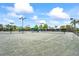 Well-lit tennis court with professional surface, perfect for friendly matches at 7716 Uliva Way, Sarasota, FL 34238