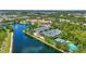 Aerial view of the community tennis courts, adjacent to a scenic lake, and close to the community center at 7716 Uliva Way, Sarasota, FL 34238