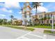 Exterior of town center with a clock tower, lush landscaping, and a pedestrian-friendly street at 7716 Uliva Way, Sarasota, FL 34238