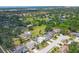 Aerial view of a home and neighborhood featuring lush green landscaping, mature trees, and nearby waterways at 7834 38Th E Ct, Sarasota, FL 34243