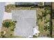 Aerial view of the roof and backyard of a single-Gathering home surrounded by lush landscaping at 7834 38Th E Ct, Sarasota, FL 34243