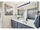 Contemporary bathroom featuring a double vanity, modern fixtures, and a stylish decorative mirror at 7834 38Th E Ct, Sarasota, FL 34243