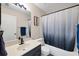 Well-lit bathroom featuring a vanity with matte black faucet, framed mirror, and a tub with a gray-scale shower curtain at 7834 38Th E Ct, Sarasota, FL 34243
