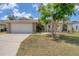 Charming single-story home featuring a two-car garage and tropical landscaping, with a well-maintained lawn at 7834 38Th E Ct, Sarasota, FL 34243