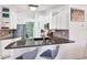 Modern kitchen bar with granite countertops, stainless steel appliances, and stylish bar stools at 7834 38Th E Ct, Sarasota, FL 34243