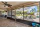 Screened-in patio with a view of the landscaped backyard, complete with a fire pit and seating area at 7834 38Th E Ct, Sarasota, FL 34243