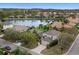 A serene aerial view of lakeside houses and a peaceful lake that create a picturesque neighborhood setting at 8222 Haven Harbour Way, Bradenton, FL 34212