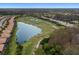 Aerial view showcases homes bordering a pond and golf course, seamlessly blending community living and recreation at 8222 Haven Harbour Way, Bradenton, FL 34212