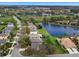 Aerial view of a residential area showcasing homes, a lake, and surrounding greenery at 8222 Haven Harbour Way, Bradenton, FL 34212