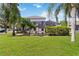 Spacious green backyard highlighting a well-maintained lawn, a screen patio, and a mix of trees at 8222 Haven Harbour Way, Bradenton, FL 34212