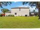 Back exterior with large green backyard, with mature landscaping, screened lanai, and ample open space at 8222 Haven Harbour Way, Bradenton, FL 34212