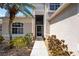 A well-lit walkway leading up to the front door, surrounded by mature landscaping and decorative gravel at 8222 Haven Harbour Way, Bradenton, FL 34212