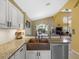 Spacious kitchen featuring stainless steel appliances, a copper sink, and views to the Gathering room at 8222 Haven Harbour Way, Bradenton, FL 34212