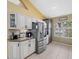 Bright kitchen featuring white cabinets, stainless steel appliances, and granite counters at 8222 Haven Harbour Way, Bradenton, FL 34212