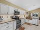 Bright kitchen with white cabinets, stainless steel appliances and granite counters at 8222 Haven Harbour Way, Bradenton, FL 34212