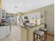 Bright kitchen featuring granite countertops, updated appliances, and a breakfast bar with seating at 8222 Haven Harbour Way, Bradenton, FL 34212