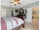 Cozy main bedroom with a ceiling fan, a large dresser with mirror, and an open ensuite bathroom at 8222 Haven Harbour Way, Bradenton, FL 34212