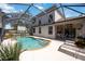 Beautiful screened-in pool area with a covered patio, outdoor seating, and well-maintained landscaping at 8222 Haven Harbour Way, Bradenton, FL 34212