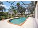 Inviting pool under a screened enclosure, complemented by lush landscaping and views of the backyard at 8222 Haven Harbour Way, Bradenton, FL 34212