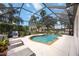 Relaxing screened-in pool area with lounge chairs and lush landscaping provides an outdoor oasis at 8222 Haven Harbour Way, Bradenton, FL 34212