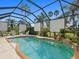 Beautiful screened-in pool area featuring a brick-trimmed pool, palm trees, and shade screens at 8222 Haven Harbour Way, Bradenton, FL 34212