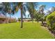 Expansive green lawn adorned with palm trees and well-kept landscaping in a residential neighborhood at 8222 Haven Harbour Way, Bradenton, FL 34212