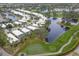 An aerial view of a neighborhood featuring golf course frontage and community lakes at 8706 52Nd E Dr, Bradenton, FL 34211