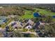 Clubhouse aerial featuring a nearby golf course, tennis courts, and parking spaces at 8706 52Nd E Dr, Bradenton, FL 34211