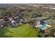 Aerial view displaying the community clubhouse, golf course, tennis courts, and other amenities at 8706 52Nd E Dr, Bradenton, FL 34211