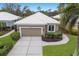 Aerial view of a single-story home with a well-manicured lawn and driveway at 8706 52Nd E Dr, Bradenton, FL 34211