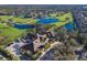 An aerial view shows a well-manicured golf course community, beautiful ponds, and a spacious clubhouse at 8706 52Nd E Dr, Bradenton, FL 34211